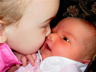 Ella gives Kate a gentle kiss.